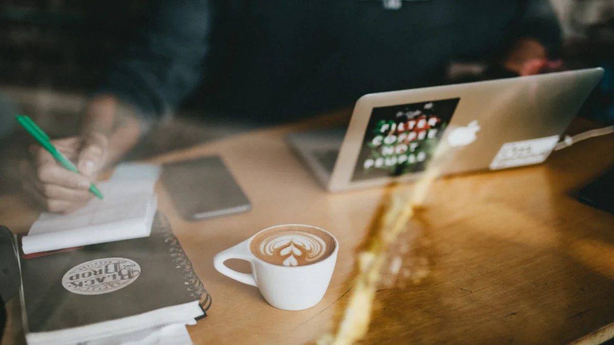 Notebook and laptop on a café table for planning