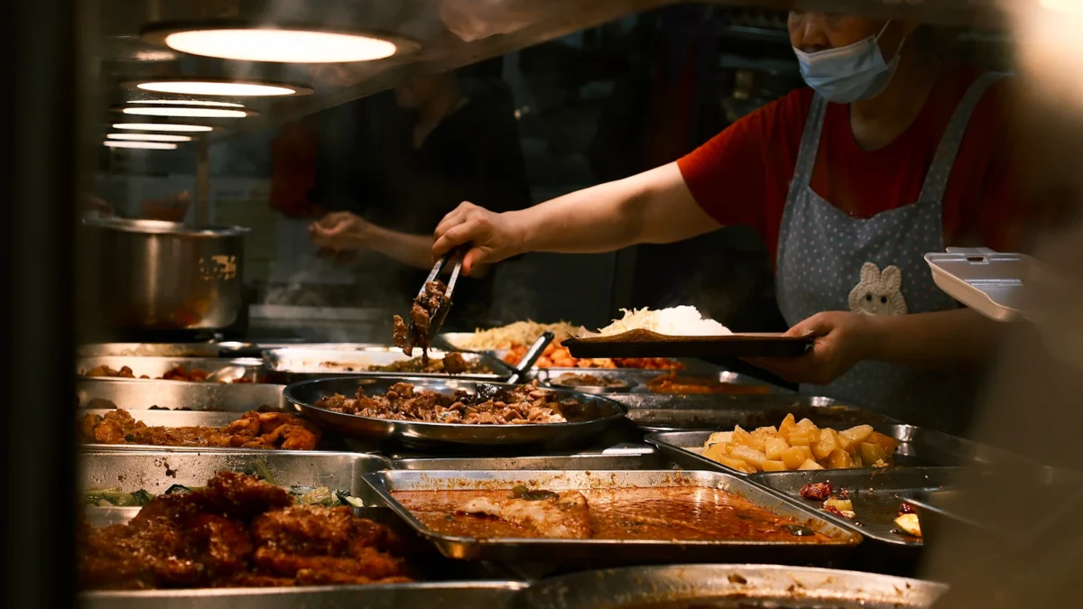 Staff serving food at a restaurant counter