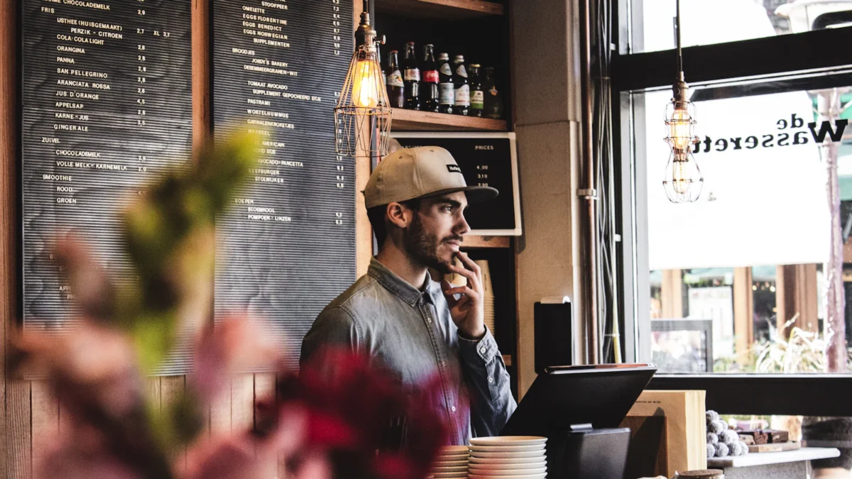 Café owner reviewing figures at the counter